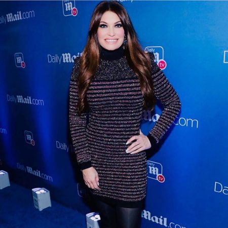 Kimberly Guilfoyle in a black t-shirt poses for a picture.